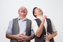 Two Caucasian Men Laughing On His Friends Joke