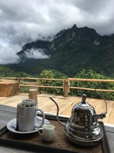 Teapot On Table Against Mountains