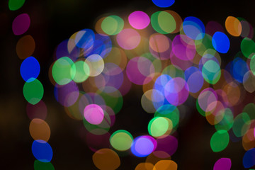 Wall Mural - multicolored bokeh on a black background