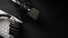 Flat Lay, Studio Microphone With Professional Headphones On A PC Keyboard. Black On A Black Background. Podcasts, Radio, Streams, Blogging, Working With Sound, Recording Tracks