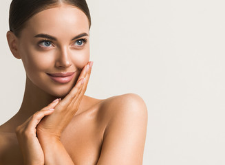 Wall Mural - beautiful woman face close up natural make up hand touching face beauty smile