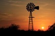 silhouette of windmill at sunset with a colorful sky in Kansas