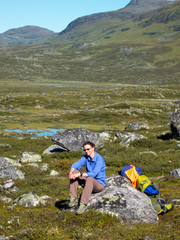 Woman having a break from hiking in swedish lapland