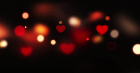 Wall Mural - motion bokeh of heart shape over dark background. valentines day video