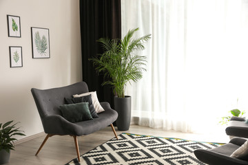 Wall Mural - Comfortable sofa near window with elegant curtains in room