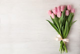 Beautiful pink spring tulips on white wooden background, top view. Space for text