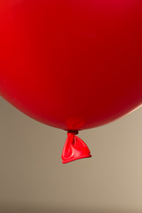 Wall Mural - red helium balloon on beige background