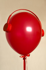 Canvas Print - red helium balloon with red retro headphones
