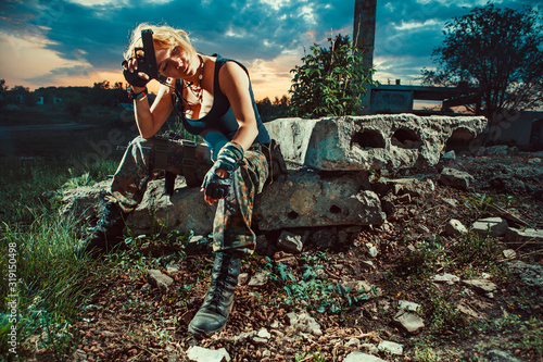 Cuadros en Lienzo Sexy woman soldier with pistol is having a rest