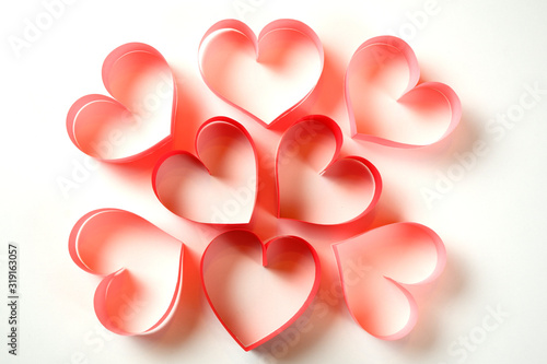 Bunch of red and pink paper hearts on white background. Good love, valentines day, womens day banner, offer, card, invitation, flyer, poster template.