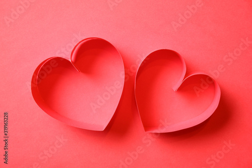 Pair of red paper hearts on red background top view. Good love, valentines day, womens day banner, offer, card, invitation, flyer, poster template.