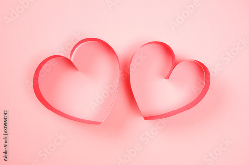 Pair of red paper hearts on pink background top closeup view. Pretty love, valentines day, womens day banner, offer, card, invitation, flyer, poster template.