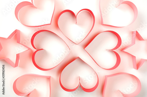 Four red, four pink of red paper hearts and pink paper stars on white background top closeup view. Pretty love, valentines day, womens day banner, offer, card, invitation, flyer, poster template.