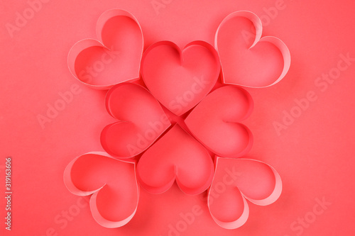 Four red and four pink of red paper hearts on red background top view. Good love, valentines day, womens day banner, offer, card, invitation, flyer, poster template.