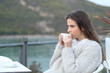 © Antonioguillem - Serious girl drinking coffee looking away in a terrace