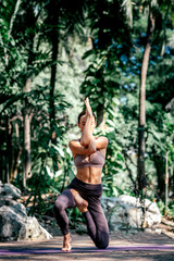 A better life with peace, love and happiness. Full-length shot of caucasian woman practicing yoga outdoors, in the nature park. Healthy lifestyle and relaxation concept. Vertical shot. Front view