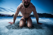 Young Man With Beard Swims In The Winter Lake