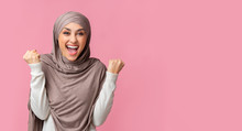 Beautiful Muslim Woman In Hijab Shaking Fists Celebrating Victory