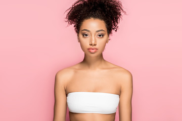 portrait of attractive african american girl with clean face, isolated on pink