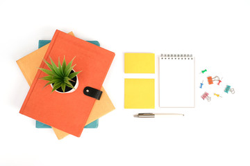 Wall Mural - Work space education and back to school concept on white modern table desk with stack of book and blank note pad, sticky note and pen, pin and paper clip, flat lay, Top view with copy space