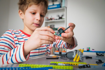 Poster - child building robot at robotic technology school lesson