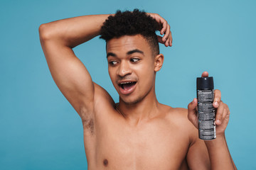 Photo of excited african american man showing his armpit and deodorant