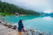 © Yuzi Photos - Girl enjoying the view of Lake Louise, Banff, Canada