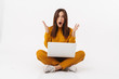 © Drobot Dean - Image of brunette adult woman screaming and holding laptop computer
