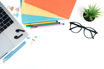 Wall Mural - Flat lay education and back to school concept on white modern table desk with laptop computer and stack of books, earphone and glasses, pin and paper clip, Top view with copy space