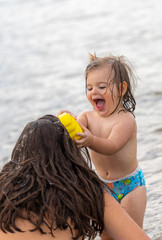 Sisters. Water. Smile. Happy. Playing. Sea