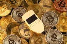 WROCLAW, POLAND - JANUARY 28, 2020: Physical Version Of Bitcoin (BTC), Trezor (cryptocurrency Hardware Wallet) And Other Cryptocurrencies Background.