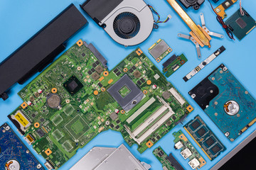 Poster - Parts of a modern computer. The insides of a laptop on a blue background, flat lay composition