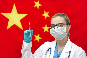 Female doctor or nurse in blue gloves holding syringe for vaccination and looking at the camera against the background of the Chinese flag. Medicine concept and fight the virus. China coronavirus.