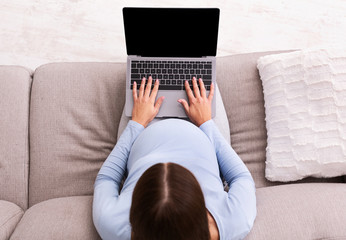 Wall Mural - Expectant Woman Typing On Laptop Sitting On Couch, Mockup, Top-View