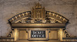 Ticket office ornate bronze sign against a brown marble wall in Chicago's Civic Opera House