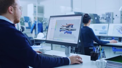 Poster - Over Shoulder: Heavy Industry Engineer Working on Personal Computer, Screen Shows CAD Software Showing New Generation Electric Engine. Industrial Factory with High-Tech CNC Machinery