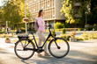 © BGStock72 - Young woman with modern city electric e-bike clean sustainable urban transportation