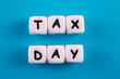 © Yevhenii - Tax concept. White plastic blocks with letters TAX DAY on a blue background.