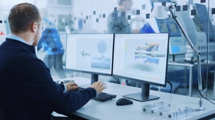 Industrial Engineer Solving Problems, Working on a Personal Computer, Using Mouse and Keyboard, Two Monitor Screens Show CAD Software with Machine Equipment in 3D. Focus on Hands