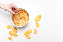 Hand With Potato Chips And Bowl On White Background