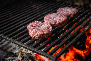 Grilled hamburgers on charcoal coals