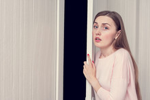 Young Woman Hiding Behind The Door, Girl Is Very Afraid Of Someone, Portrait, Copy Space, Toned
