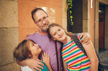 Wall Mural - Outdoor portrait of happy father with young kids