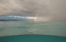 Rainbow On A Cloudy Day Over Tropical Lagoon