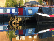 Old Narrow Boats And Barges Converted To Houseboats Moored In The Marina At Brighouse Basin In West Yorkshire