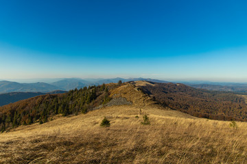 Wall Mural - mountain ridge landscape highland scenic view early spring time season weather horizon background blue sky copy space