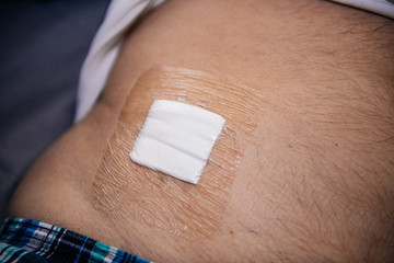 senior man torso with medical patch after performed biopsy clean medical procedure inspection