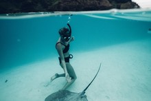 Woman Swims With Stingray In Tropical Water