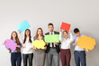 © Pixel-Shot - Group of business people with blank speech bubbles on light background