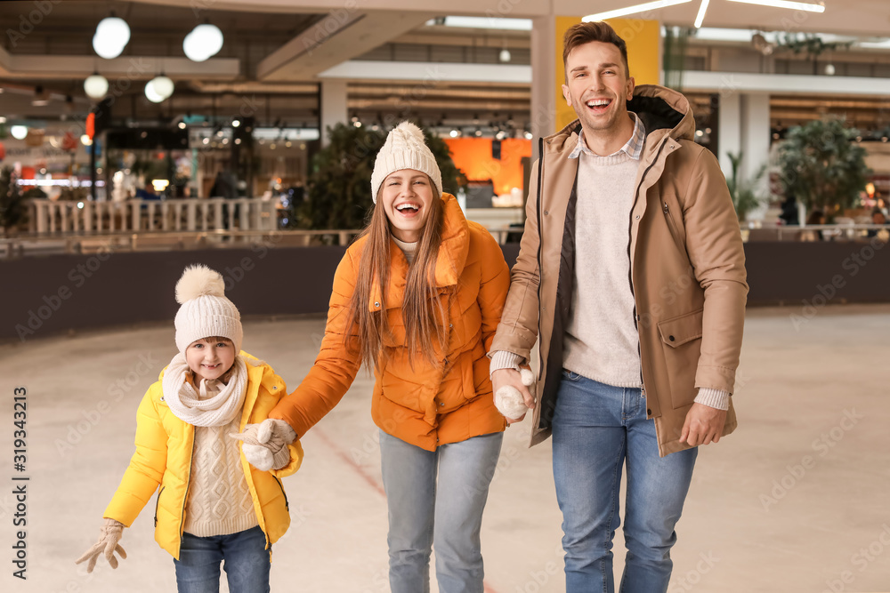 Happy family on skating rink